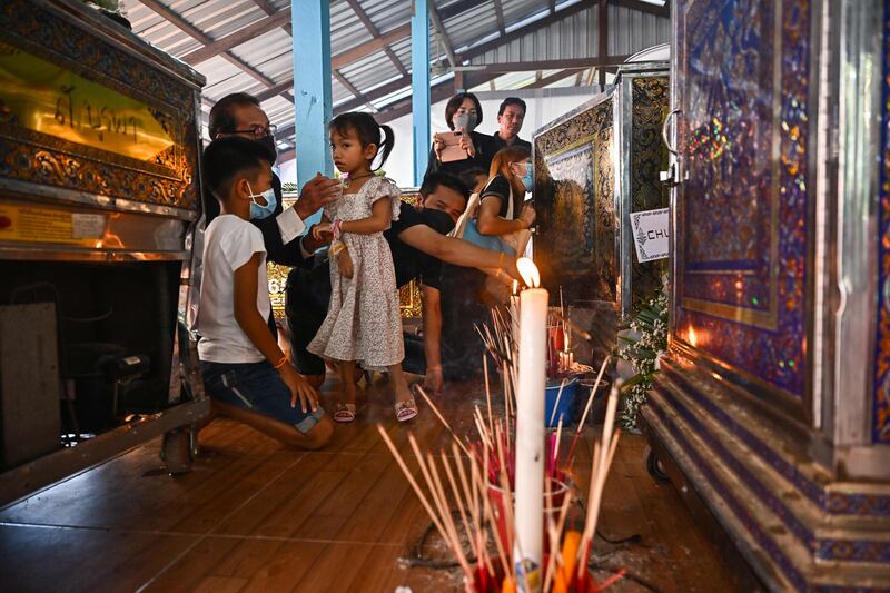 Relatives gather in front of the coffin of their loved one killed in the mass shooting. AFP