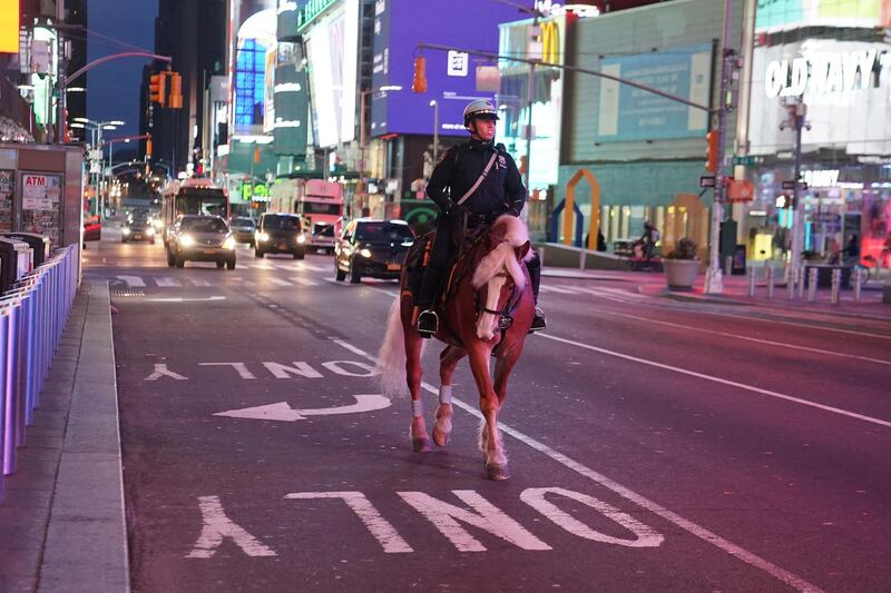 A mounted police officer rides though a mostly deserted Times Square during the outbreak of the coronavirus disease in the Manhattan. Reuters
