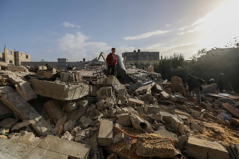 People inspect damage and recover items from their homes following Israeli air strikes, on Sunday in Rafah, Gaza. Getty Images