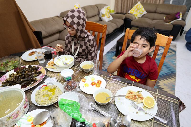 Rayan breaks his fast with his sister Tala, 10. Chris Whiteoak / The National