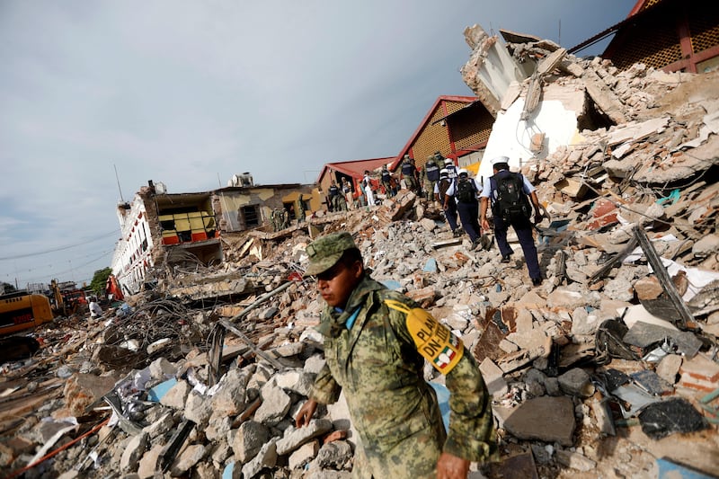 Soldiers work to remove the debris of a house destroyed in an earthquake that struck off the southern coast of Mexico. Edgard Garrido / Reuters