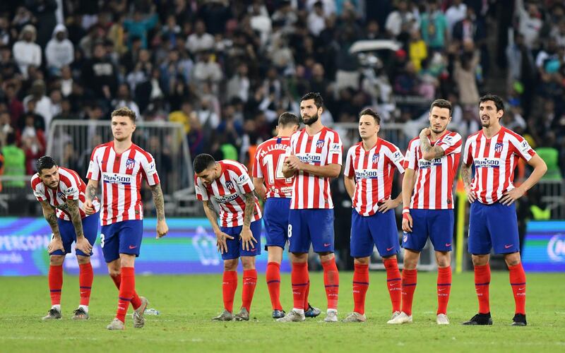 Atletico Madrid players look dejected during the penalty shootout before Real Madrid win the Super Cup. Reuters