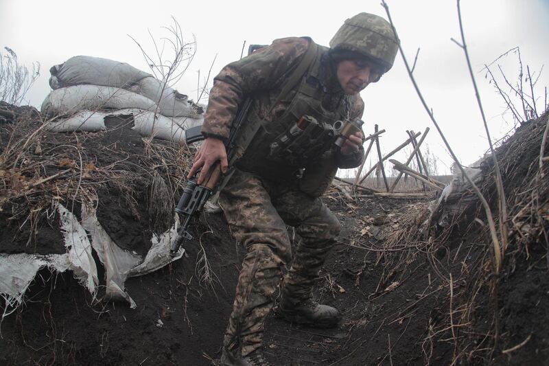 A service member of the Ukrainian armed forces is seen at fighting positions on the line of separation near the rebel-controlled city of Donetsk, Ukraine April 3, 2021. REUTERS/Serhiy Takhmazov