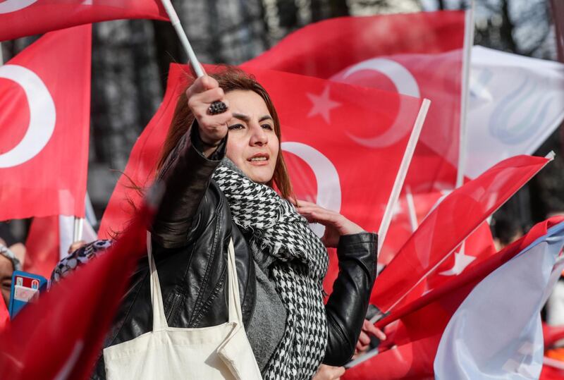 A member of a Turkish community welcomes Turkish President Erdogan ahead of a meeting and a press conference with NATO Secretary General Jens Stoltenberg  in Brussels.  EPA