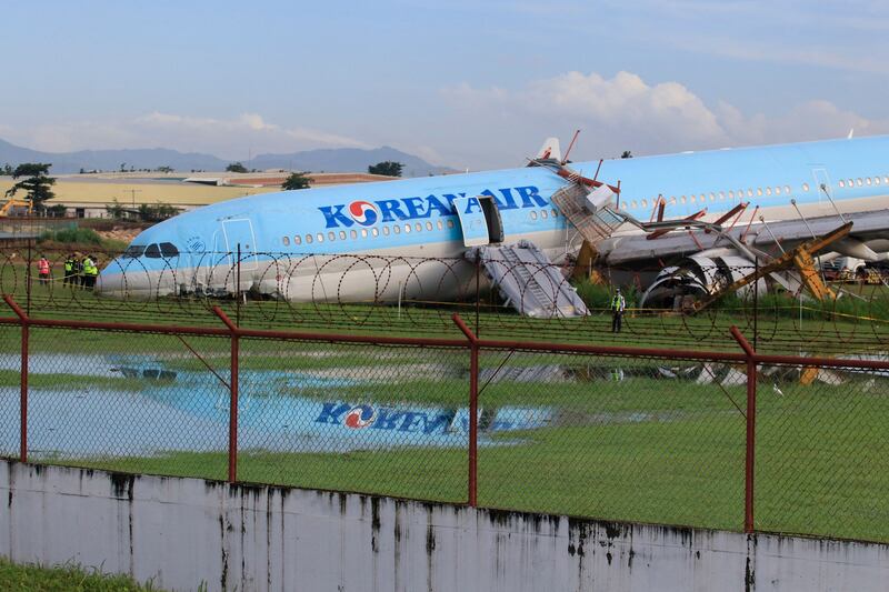 A Korean Air passenger plane lies at the airport in Cebu City, central Philippines, after it overshot the runway while landing in bad weather.  AFP