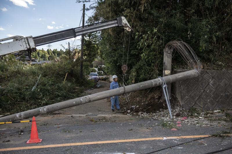 A utility company worker removes an electricity pole in Chiba, Japan. Getty Images