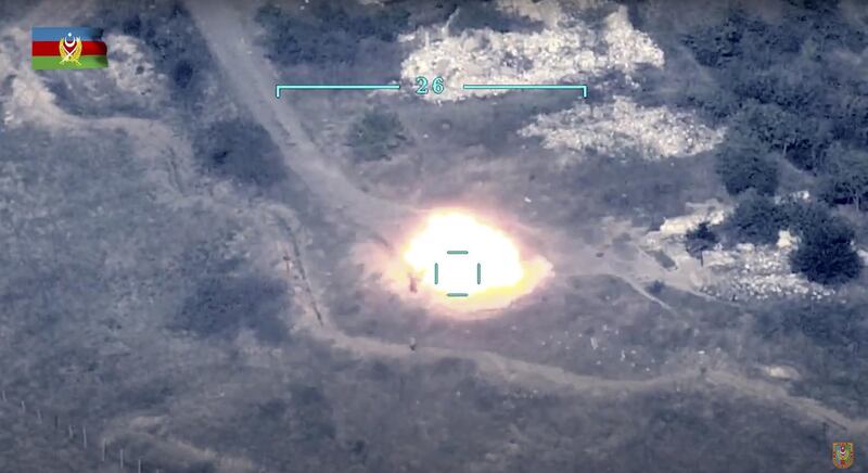 In this handout photo taken from a footage released by Azerbaijan's Defense Ministry, Azerbaijan's forces destroy Armenian anti-aircraft system at the contact line of the self-proclaimed Republic of Nagorno-Karabakh, Azerbaijan.  AP