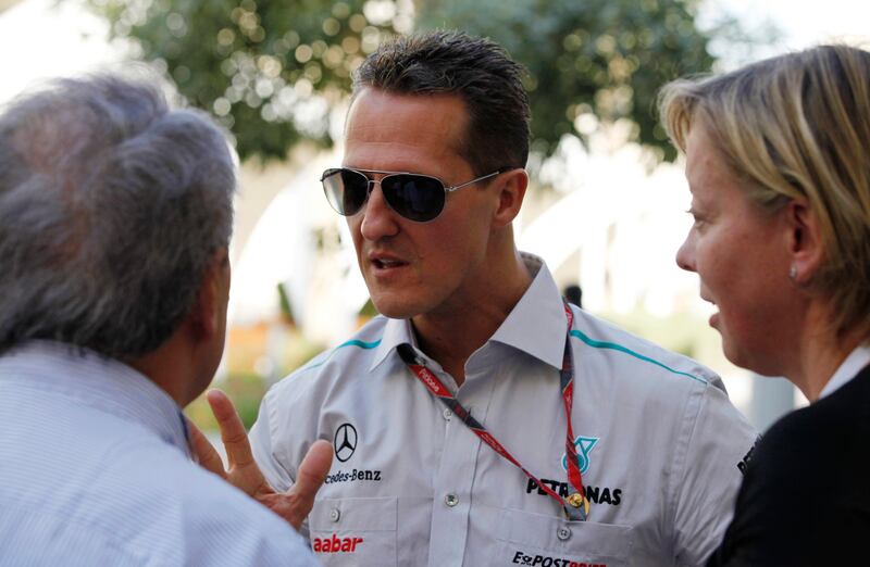 Mercedes Formula One driver Michael Schumacher (L) of Germany speaks to the media at the paddock ahead of the Abu Dhabi F1 Grand Prix at the Yas Marina circuit in Abu Dhabi November 10, 2011. REUTERS/ Hamad I Mohammad (UNITED ARAB EMIRATES - Tags: SPORT MOTORSPORT) *** Local Caption ***  HAM12D_MOTOR-RACING_1110_11.JPG