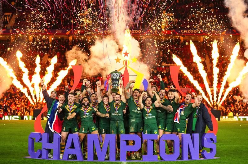 Australia celebrates with the trophy after winning the Rugby League World Cup final against Samoa at Old Trafford in Manchester, England. AP