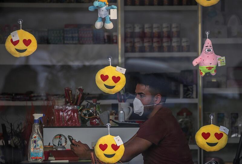 A shop owner wears a protective face mask in Gaza City. EPA