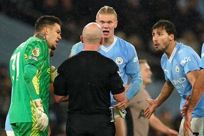 Manchester City's Erling Haaland, goalkeeper Ederson, left, and Ruben Dias, right, remonstrate with referee Simon Hooper. PA
