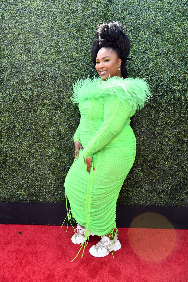 Lizzo wearing lime green Christopher John Rogers to the 2019 MTV Movie and TV Awards. Getty Images