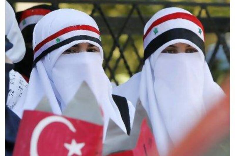 Syrian opposition demonstrators living in Jordan attend a rally in front of the Turkish embassy in Amman yesterday in support of Turkey's stance against Syria's President Bashar Al Assad. Ali Jarekji / Reuters