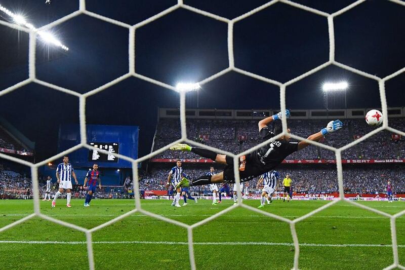 Barcelona’s Lionel Messi scores the opening goal against Alaves. David Ramos / Getty Images