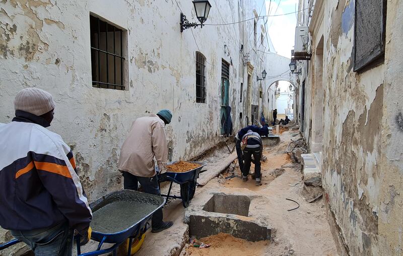 Labourers work on the restoration project in an alley of Tripoli's Old City. AFP