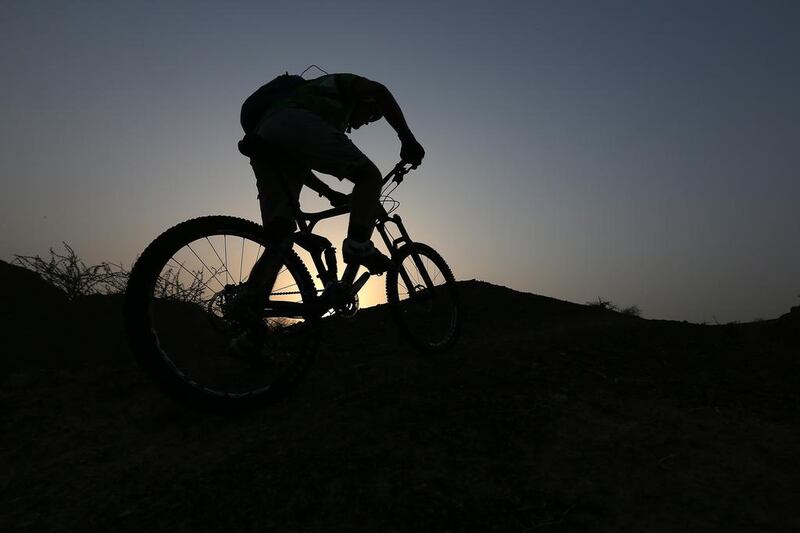 The keenest mountain bikers in the UAE take to night-biking when temperatures rise in the UAE. Pawan Singh / The National 