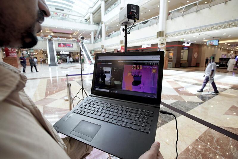 Abu Dhabi, United Arab Emirates, March 11, 2020. 
A thermal scanner technician keeps a watchfull eye on the newly intalled thermal scanners at the Khalidiyah Mall, Abu Dhabi.
Victor Besa / The National
Section:  NA
Reporter:  Kelly Clarke