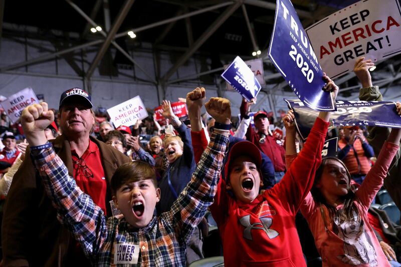 Young supporters cheer as U.S. President Donald Trump speaks during a campaign rally in Tupelo, Mississippi, U.S. Reuters