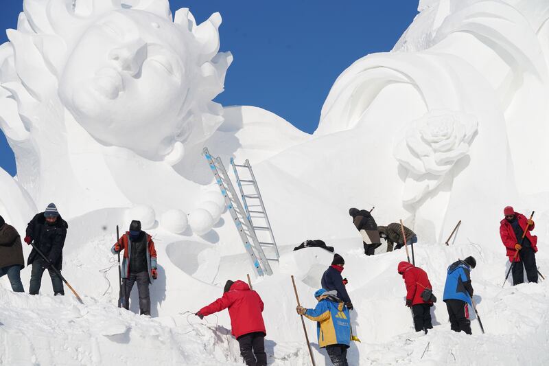 Staff members work on a gigantic snow sculpture for the upcoming 35th Taiyangdao Island (Sun Island) International Snow Sculpture Expo in Harbin, Heilongjiang Province, China, 18 December 2022 (issued 19 December 2022).   EPA / XINHUA  /  WANG SONG CHINA OUT  /  MANDATORY CREDIT  EDITORIAL USE ONLY