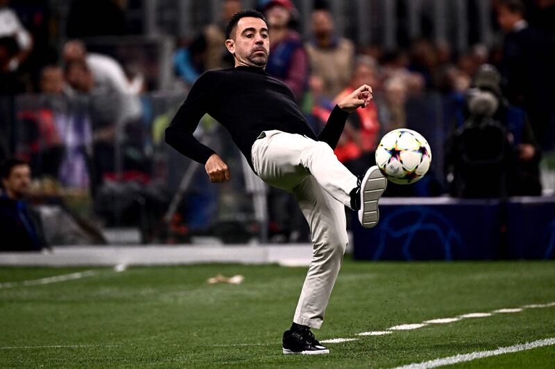Barcelona coach Xavi Hernandez kicks the ball on the touchline. AFP