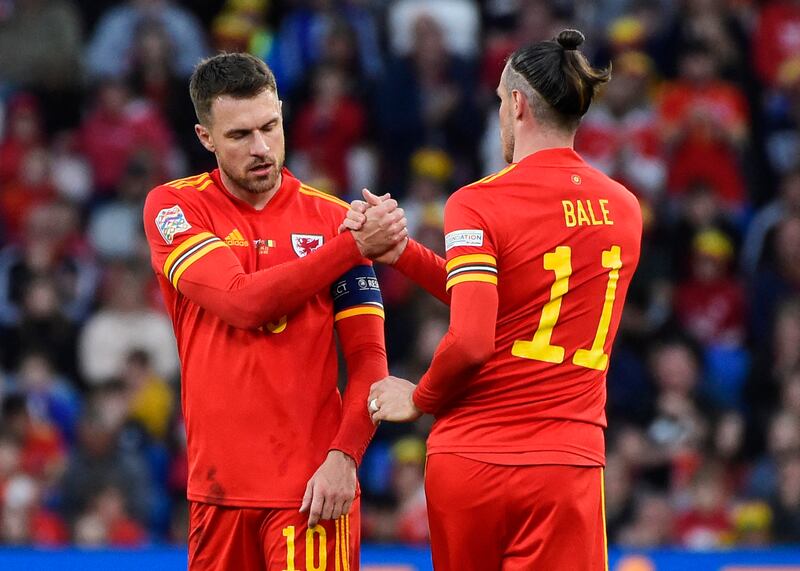 Gareth Bale shakes hands with Aaron Ramsey. Reuters