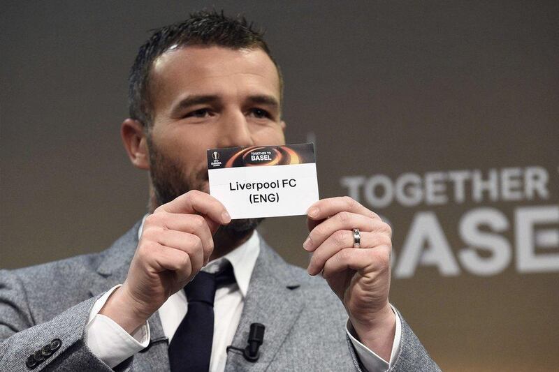 Former Swiss forward and this year's UEFA Europa League final ambassador Alexander Frei shows the name of Liverpool during the round of 16 draw of the UEFA Europa League football championship at the UEFA headquarters in Nyon on February 26, 2016. AFP PHOTO / ALAIN GROSCLAUDE