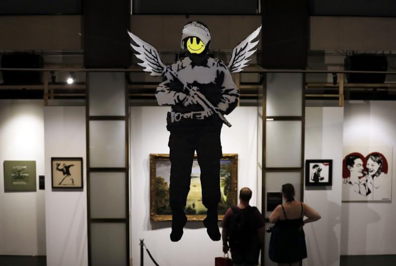 epa06039368 A giant spray paint on card of the 'Flying Copper' by British Banksy is on display at the exhibition 'The Art of Banksy' in Berlin, Germany, 20 June 2017. Original canvasses, paintings, sculptures and a interactive storytelling show the career of this unknown street artist. All pieces come from private collectors and the curator's Steve Lazarides collection. The exhibition runs from 15 June to 15 September 2017.  EPA/FELIPE TRUEBA