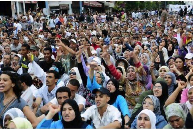 Members of the Islamist movement Al Adl Wal Ihssane (Justice and Charity) protest in the streets of Casablanca on Sunday against the new constitution. Al Adl Wal Ihssane is a part of a coalition that forms the opposition movement February 20 Selmaoui-Karim / EPA