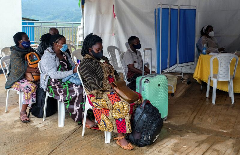 Travellers wait for a coronavirus test at the Gatuna border post at Gicumbi, northern Rwanda. Reuters