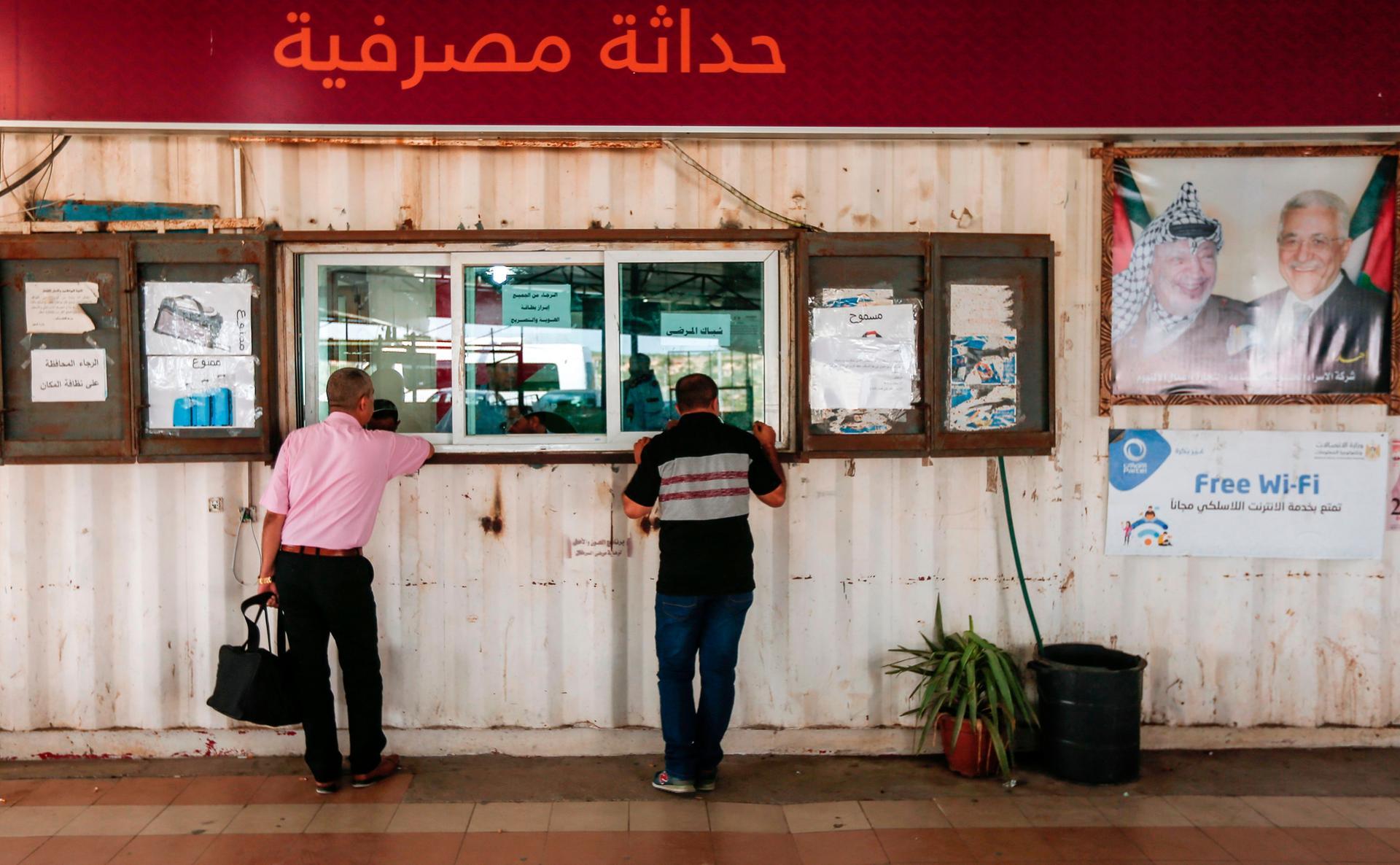 Palestinians present their travel documents to Palestinian Authority officers at the Erez crossing with Israel near Beit Hanun in the northern Gaza Strip on  August 27, 2018. (Photo by MAHMUD HAMS / AFP)