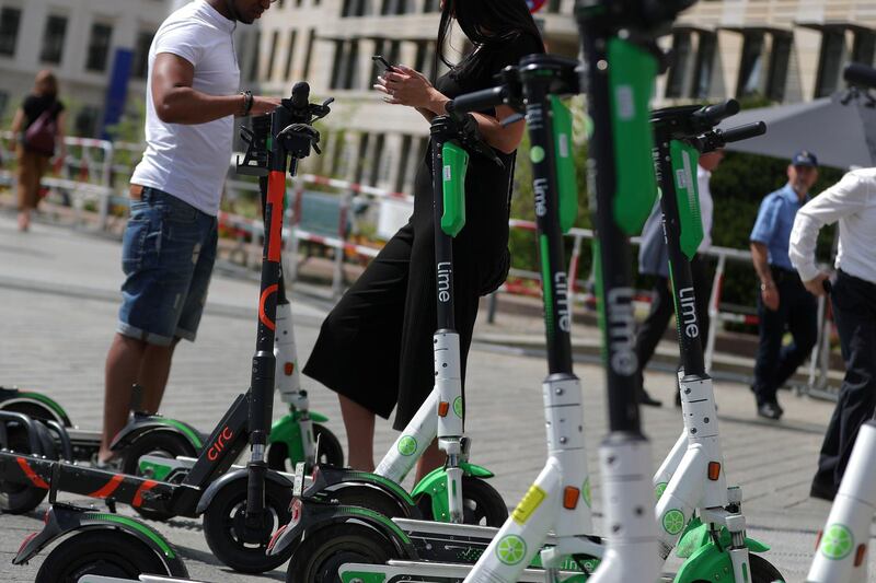 Customers use smartphone apps to hire Lime and Circ electric scooters in Berlin, Germany, on Thursday, July 18, 2019. Demand for e-scooters in cities worldwide have helped the industry's biggest players, such as Bird Rides Inc. and Lime, achieve multi-billion-dollar valuations in less than two years. Photographer: Krisztian Bocsi/Bloomberg