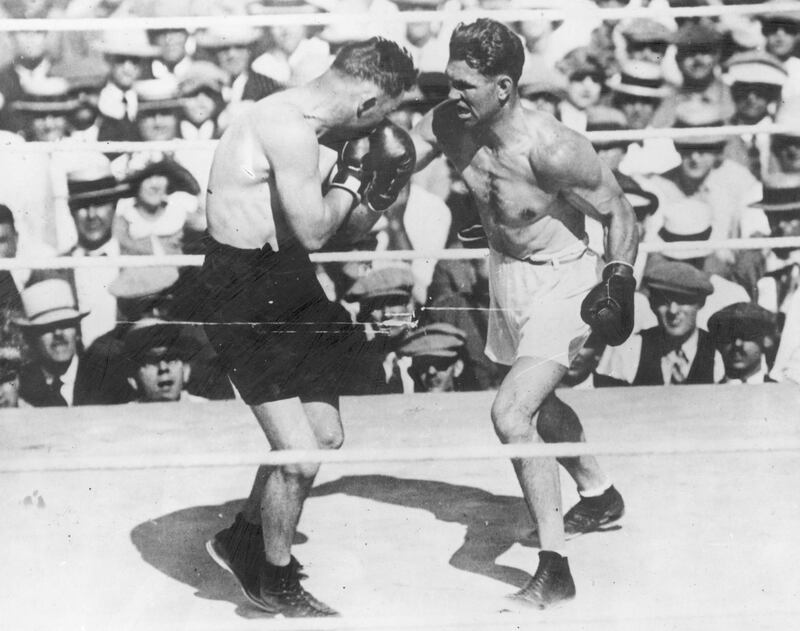 July 1923:  American world champion heavyweight boxer Jack Dempsey in action against Tom Gibbons of the USA during their fight at Shelby, Montana.  (Photo by Topical Press Agency/Getty Images)