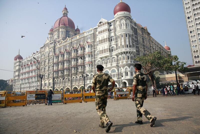 Indian police officers walk outside the Taj Mahal Hotel, one of the sites of the Mumbai terror attacks on its ninth anniversary in Mumbai, India, Sunday, Nov. 26, 2017. The attack by Pakistani gunmen in India's financial capital on Nov. 26, 2008 killed 166 people and shattered relations between the nuclear-armed neighbors. (AP Photo/Rafiq Maqbool)