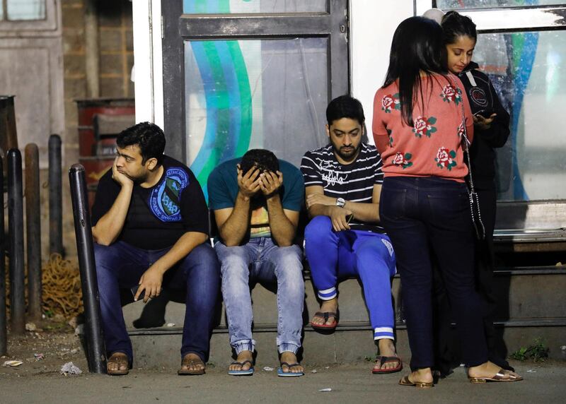 Friends of victims wait at a hospital after a fire that killed and injured several people in Mumbai on December 28, 2017. Most of those who died were young women attending a birthday party.  Danish Siddiqui / Reuters