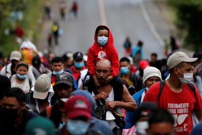 Hondurans taking part in a new caravan of migrants set to head to the United States, walk along a road in El Florido, Guatemala January 16, 2021. REUTERS/Luis Echeverria     TPX IMAGES OF THE DAY
