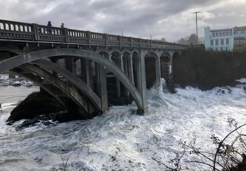 Heavy surf surrounds the legs of a bridge as an extreme high tide rolls into the harbor in Depoe Bay, Oregon during a so-called "king tide" that coincided with a big winter storm, January 11, 2020. AP Photo