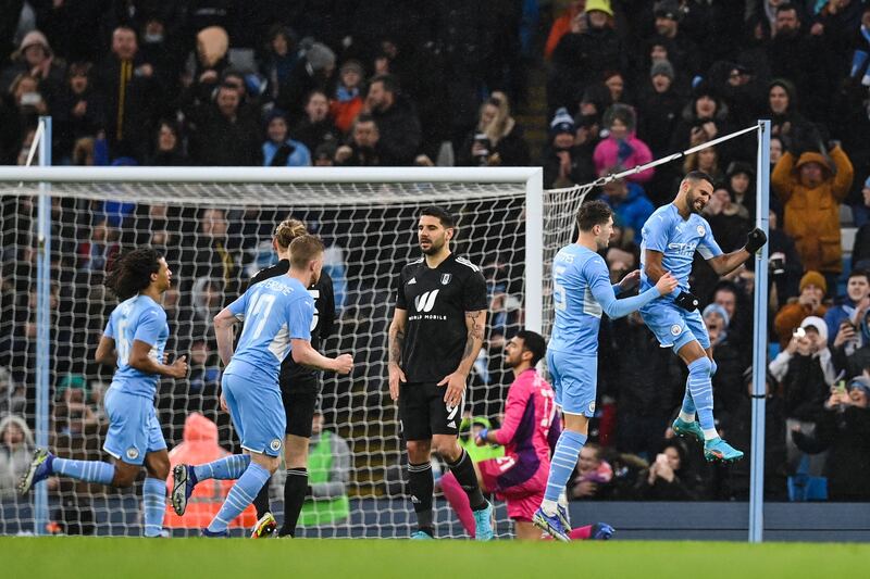 Manchester City's Algerian midfielder Riyad Mahrez, right, celebrates after scoring against Fulham at the Etihad Stadium. AFP