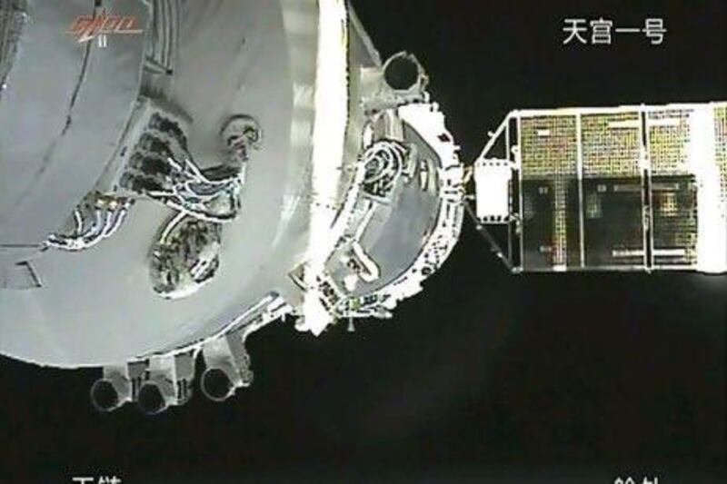 In this image taken from China's CCTV via APTN, a video image show the docking of the Shenzhou 8 craft with the already orbiting Tiangong 1 module last week. AP Photo / CCTV via APTN