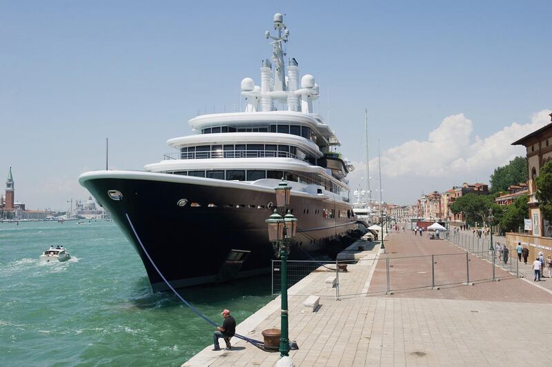 VENICE, ITALY - JUNE 05:  A man attempts to fish in front of the super yacht "Luna" owned by Russian billionaire Roman Abramovich and currently moored in Riva Sette Martiri overlooking St Mark's Basin between the Biennale Gardens and St Mark's Square as people walk around the security barriers surrounding it on June 5, 2011 in Venice, Italy. Most Venetians are against the arrival and mooring of super yachts and Venice Mayor Giorgio Orsoni has suggested imposing an eco-tax to limit the presence of these giant vessels in the basin.  (Photo by Marco Secchi/Getty Images)