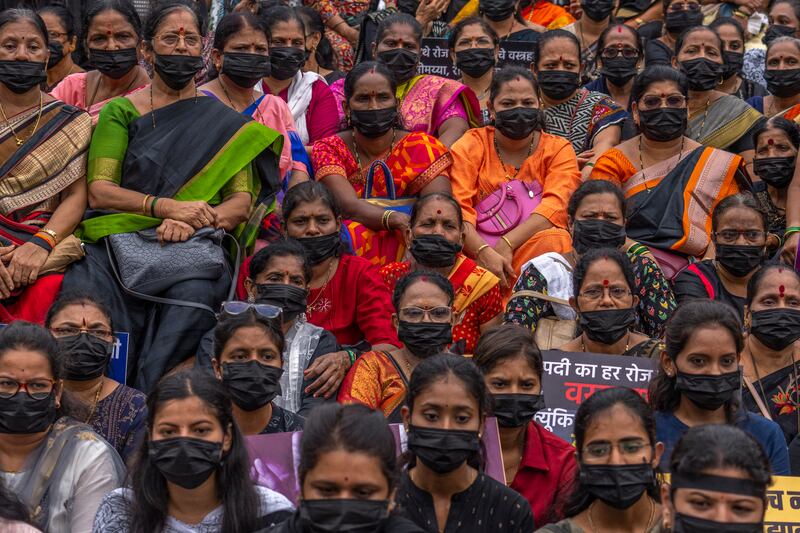 Supporters Shiv Sena wearing black masks sit on a silent protest for calling for an end to violence against women in Mumbai, India, Wednesday, Aug.  2, 2023.  (AP Photo / Rafiq Maqbool)