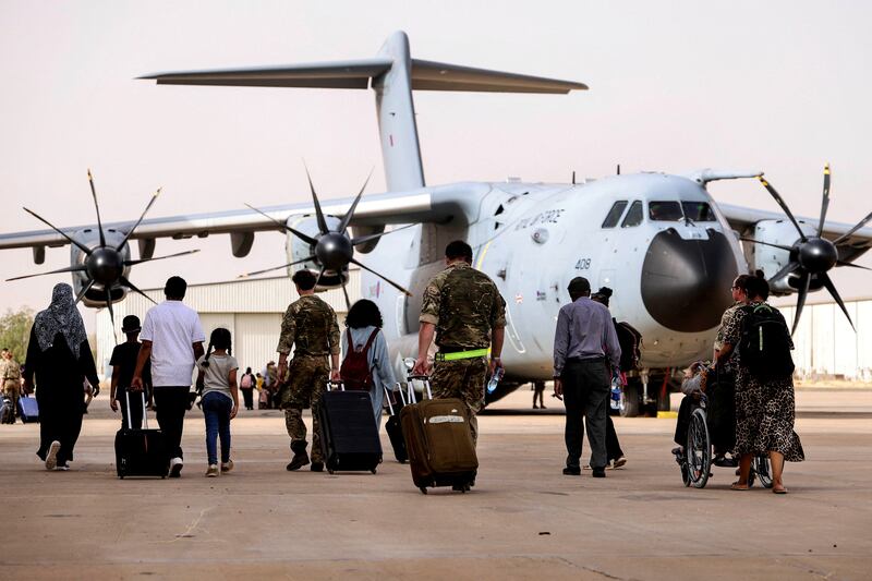 British nationals about to board an RAF aircraft during the evacuation to Cyprus, at Wadi Saeedna airport, Sudan, on April 26. Reuters