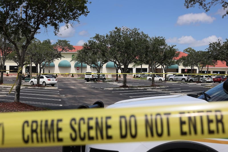Palm Beach County Sheriff’s crime scene tape is seen outside of a Publix supermarket where a woman, child and a man were found shot to death in Royal Palm Beach, Florida. Law enforcement officials continue to investigate the crime scene for clues as to why the shooting occurred. Getty Images
