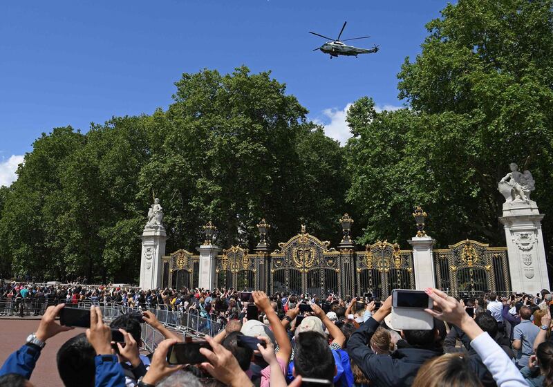 Crowds of onlookers film the Marine One helicopter as it comes in to land carrying US President Donald Trump and US First Lady Melania Trump, arriving to attend a welcome ceremony at Buckingham Palace in central London. AFP