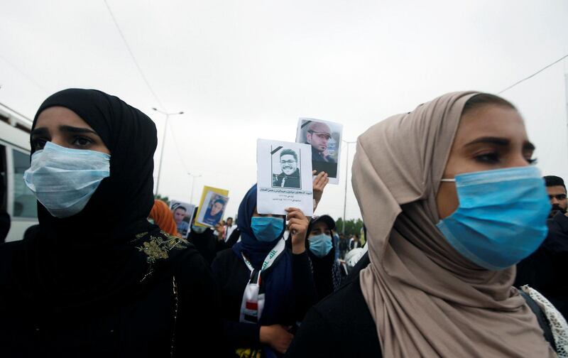 University and college students carry pictures of people who were killed at an anti-government protests, in Basra. Reuters