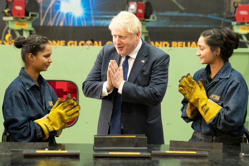 Boris Johnson meets workers at the JCB factory in Vadodara. AP