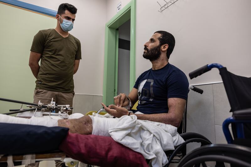 Ibrahim Amman, 30, is recovering at Al-Awda hospital, his legs sitting in external fixtures.