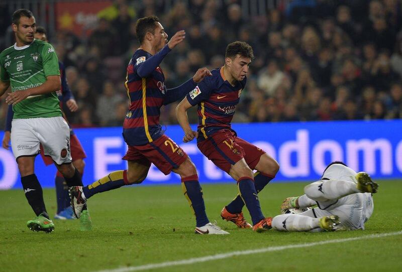 Barcelona’s Munir El Haddadi and Adriano, left, attack the ball during their match against Villanovense on Wednseday night at the Camp Nou. Lluis Gene / AFP