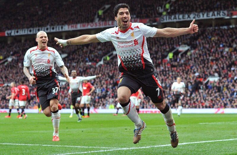 Luis Suarez celebrates after scoring Liverpool's third goal with defender Martin Skrtel on Sunday. Paul Ellis / AFP / March 16, 2014