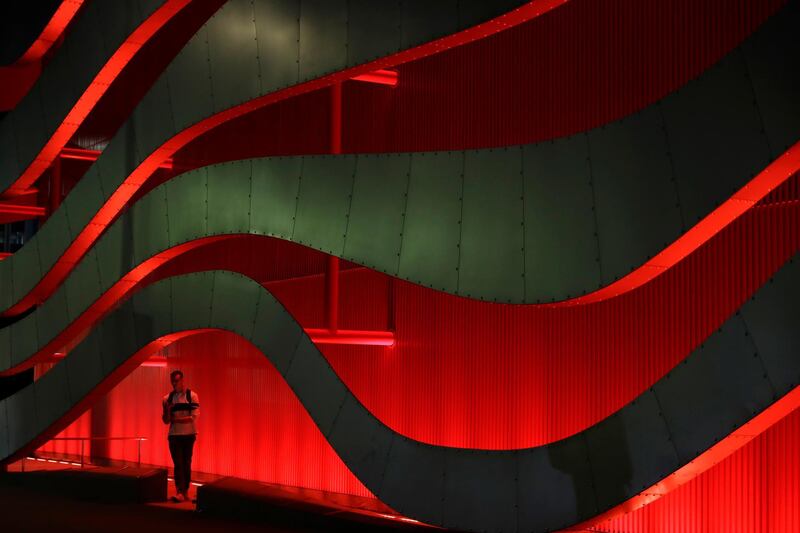 A man pauses to check his cell phone at Petersen Automotive Museum in Los Angeles, USA. Marcio Jose Sanchez / AP Photo