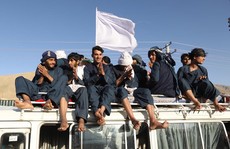 Afghan civilians carrying Afghan national flag along with Taliban flag and celebrate during a three-day ceasefire on the second day of Eid al-Fitr, in the outskirt of Kabul, Afghanistan, on June 16, 2018. Jawad Jalali / EPA